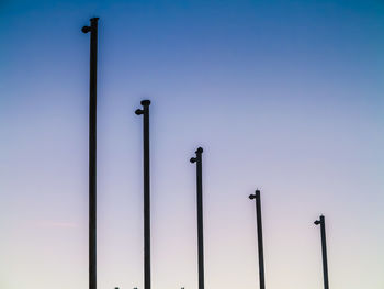Low angle view of street lights against clear sky