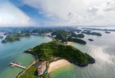 High angle view of city by sea against sky