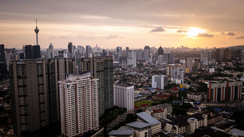 High angle view of city buildings during sunset