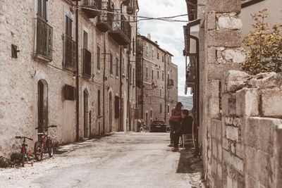 Rear view of man walking on street in city