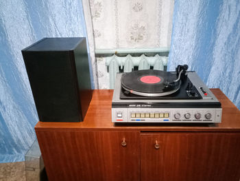 High angle view of telephone booth on table against wall