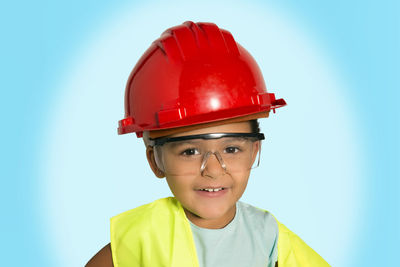 Portrait of boy wearing hat against blue sky