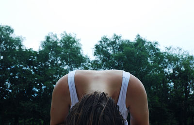 Rear view of woman wearing hat against trees