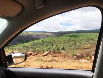 Scenic view of landscape seen through car windshield