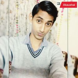 Portrait of young man standing against wall