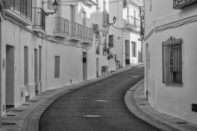 Empty narrow alley along buildings