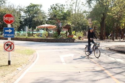 Man riding bicycle on road