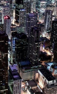 High angle view of illuminated buildings in city at night