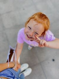 High angle portrait of cute girl standing outdoors