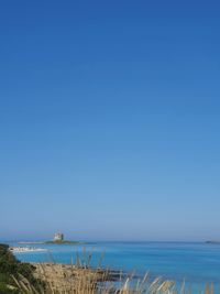 Scenic view of sea against clear blue sky