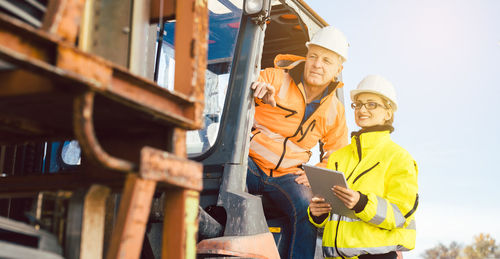 Low angle view of man working on mobile phone