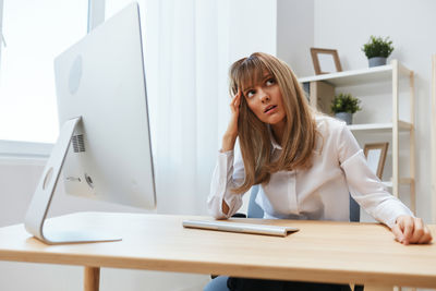 Young businesswoman working at desk in office