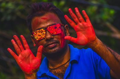 Portrait of a male happy indian celebrating holi with powder paint. concept of indian festival holi.