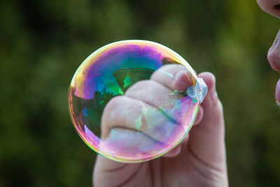 Close-up of hand holding bubbles