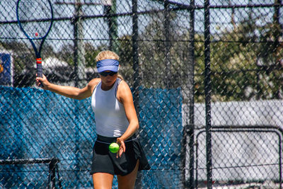 Full length of boy playing tennis