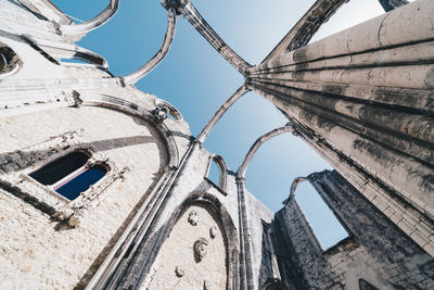 Low angle view of abandoned historic building against sky