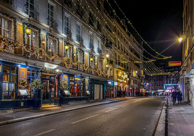 Illuminated city street at night