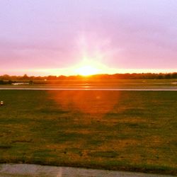 Scenic view of field against sky during sunset