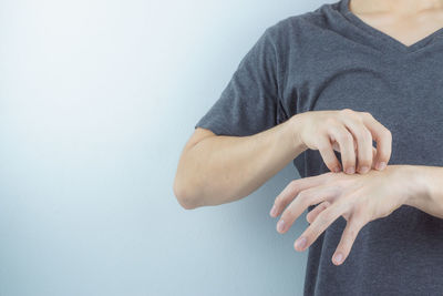 Midsection of couple against white background