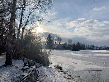 Scenic view of snow covered land against sky