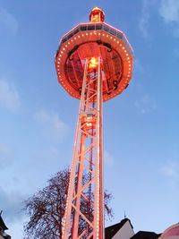 Low angle view of illuminated tower against sky