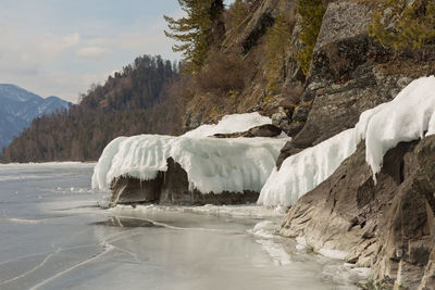 View of beautiful drawings on ice from cracks on the surface of lake teletskoye in winter, russia