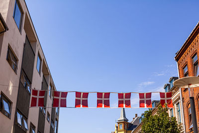 Low angle view of buildings against clear blue sky