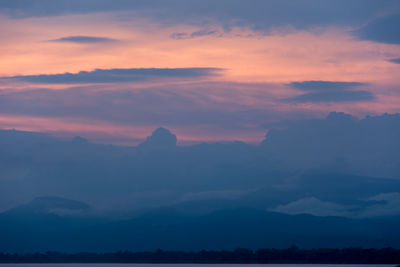 Scenic view of silhouette mountains against sky at sunset