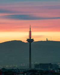 Tower and buildings against sky during sunset