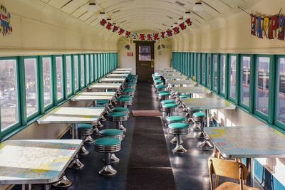 Empty chairs and tables in restaurant