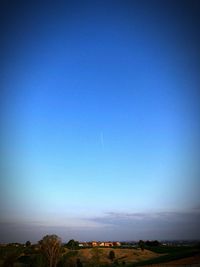 Scenic view of field against clear blue sky