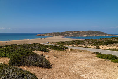 Scenic view of beach against blue sky