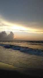 View of sea against cloudy sky during sunset