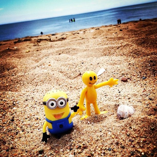 beach, sea, sand, shore, horizon over water, water, childhood, yellow, tranquility, toy, beauty in nature, nature, tranquil scene, scenics, sky, vacations, summer, day, sunlight, outdoors