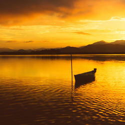 Scenic view of lake against orange sky golden hour