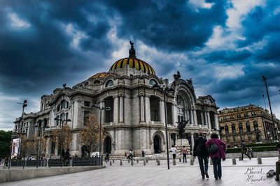 Facade of church against cloudy sky