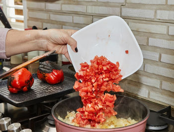 Cropped hand of person preparing food