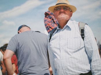 Midsection of man wearing hat standing outdoors