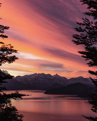 Scenic view of lake against orange sky