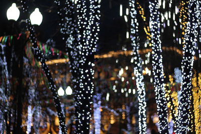 Low angle view of illuminated lanterns hanging at night