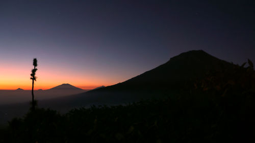 Scenic view of silhouette mountains against sky at sunset