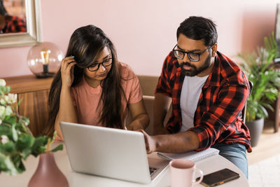 Young woman using laptop at office