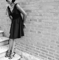 Full length of a young woman standing on tiled floor