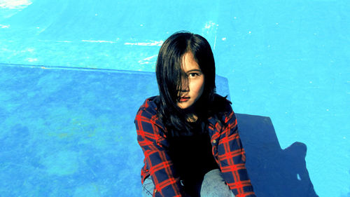 Portrait of woman sitting in swimming pool