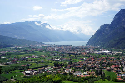 Scenic view of townscape and mountains against sky