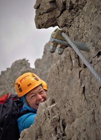 Close-up of man with arms outstretched on rock