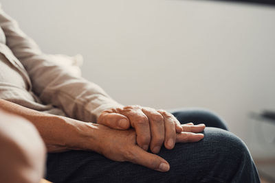 Low section of woman holding hands