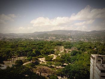 High angle view of houses against cloudy sky