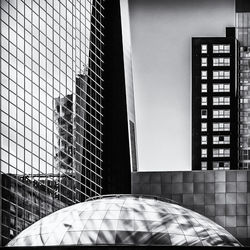 Close-up of modern office building against sky