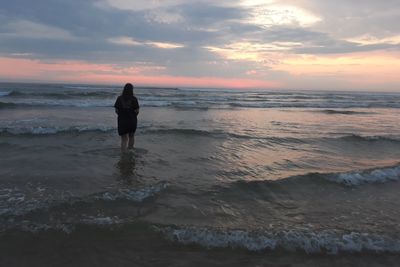 Full length of man standing on beach during sunset